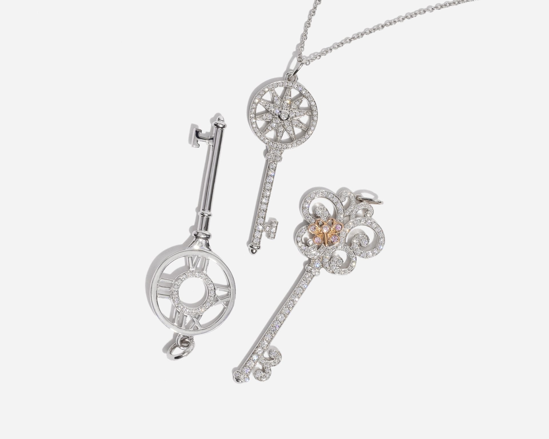 Tiffany Keys pendants in diamonds and white gold — Atlas, daisy and fleur-de-lis keys