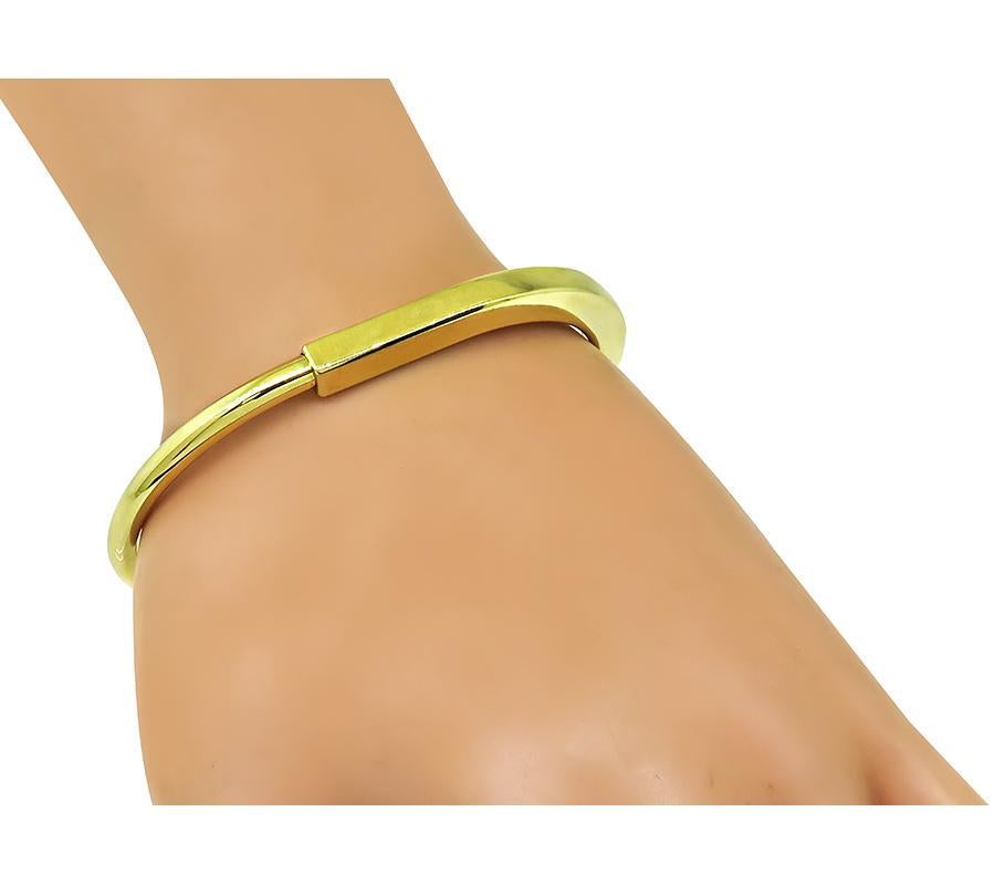 Tiffany Lock yellow gold bangle on the wrist