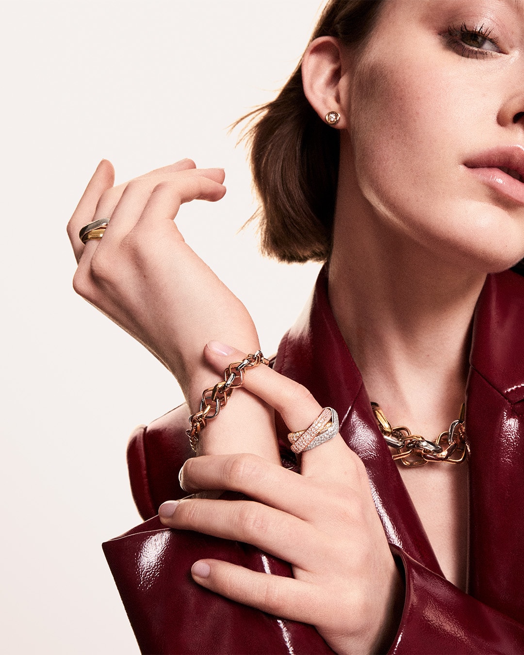 A lady wearing Cartier Trinity rings and a Trinity chain
